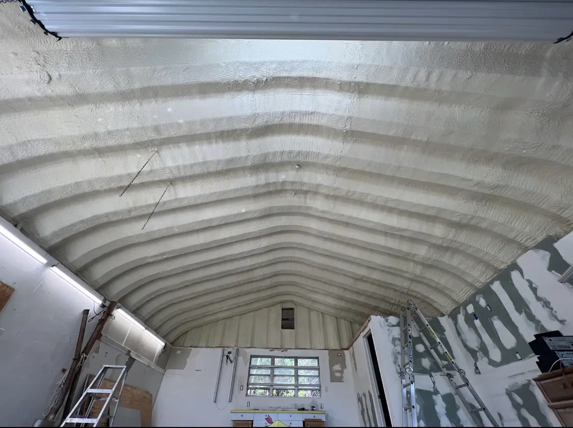 Spray polyurethane foam applied to the underside of a metal roof deck in Penn Forest